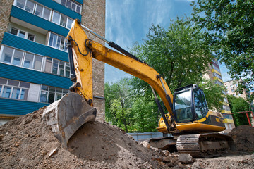Repair of city communications. Pipeline installation. Excavator at construction site in the city...