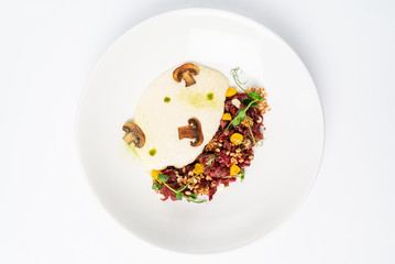 plate with delicious tartare and mushroom puree. Isolated on the white background