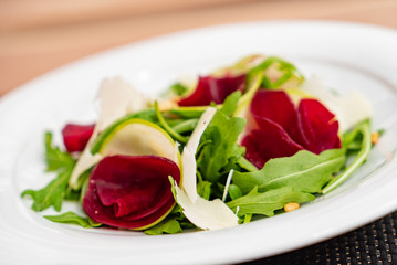 beetroot carpaccio with arugula leaves