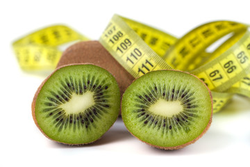 Slaced kiwi fruit and measuring tape isolated on white background