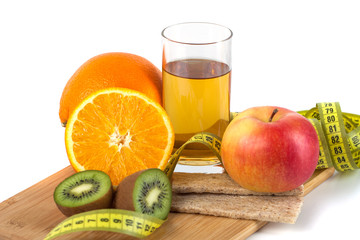 fruits, eggs, orange, apple juice on the wooden board with measurement isolated on white