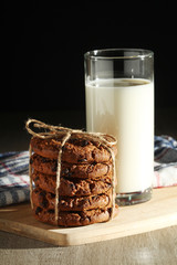 A glass with milk and chocolate cookies