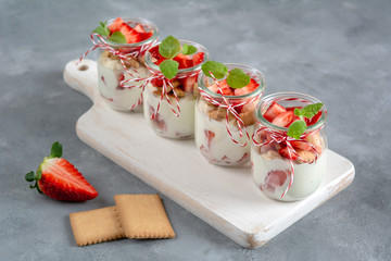 Yoghurt with fresh strawberries and crumbled biscuits. Healthy breakfast.
