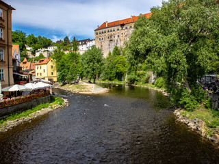 Fototapeta na wymiar View of the Unesco World Heritage City Český Krumlov in the Czech Republic with historic buildings, churches and narrow streets in front of blue sky
