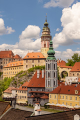 Fototapeta premium View of the Unesco World Heritage City Český Krumlov in the Czech Republic with historic buildings, churches and narrow streets in front of blue sky