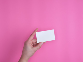 empty white rectangular business card in a female hand