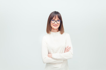 Portrait of beautiful young woman in eyeglasses on white background