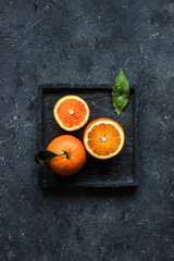 Orange fruit background. Blood orange fruits on gray background top view.