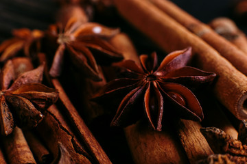 Spices sticks cinnamon and star anise on the old table. Rustic dark background, aroma close-up, macro.