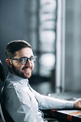 successful business office worker in the workplace with glasses and a beard. concept of career corporation.