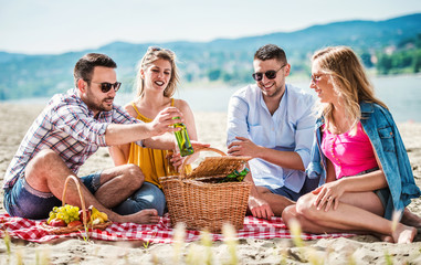 Beach picnic with friends. Lifestyle, vacation concept
