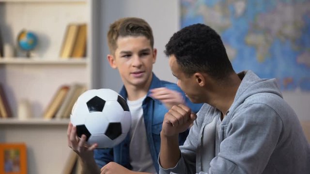 Afro-American and Caucasian guys disappointed with football team losing match