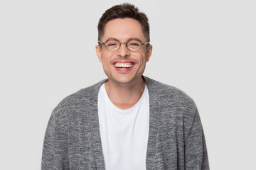 Fototapeta premium Funny happy millennial man wearing glasses laughing looking at camera