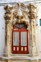 The door facade of a baroque house in Ostuni, Puglia, Italy