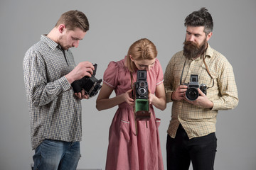 Life is full of beautiful moments remember them. Photography studio. Photographers with vintage old cameras. Group of people with retro cameras. Retro style woman and men hold analog photo cameras