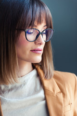 Fototapeta premium Portrait of beautiful young woman in eyeglasses