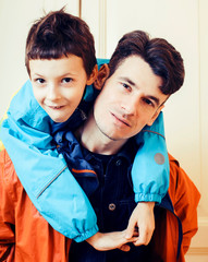 young handsome father with his son fooling around at home, lifestyle people concept close up