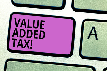 Writing note showing Value Added Tax. Business photo showcasing Amount of money added to cover production and distribution Keyboard key Intention to create computer message pressing keypad idea
