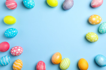 Flat lay composition with Easter eggs on color background, space for text. Top view