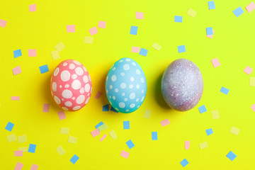 Decorative Easter eggs on color background, space for text. Top view