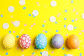 Decorative Easter eggs on color background, space for text. Top view