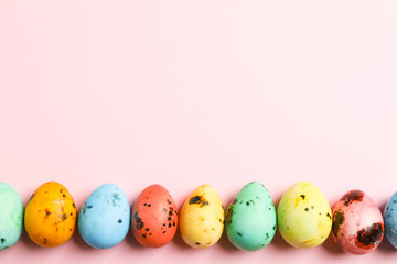 Decorative Easter eggs on color background, space for text. Top view