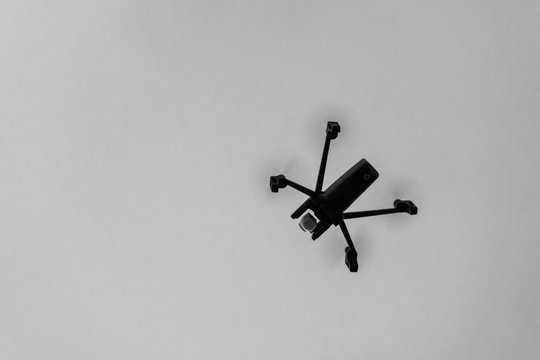 Drone aka unmanned airborne vehicle taking aerial pictures black and white