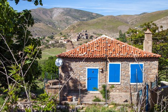 aegean architecture, Old stone homes with blue shutters and door in Derekoy, Gokceada