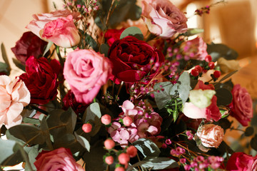 A bright large bouquet of various flowers of red and pink color