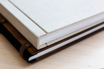 Photo book with a cover of genuine leather. White color with openwork stamping. Soft focus.