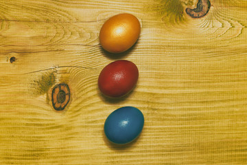 Painted Easter eggs  on wooden table.Toned photo.