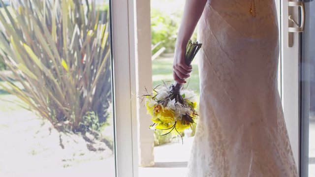 Bride holding yellow bouquet