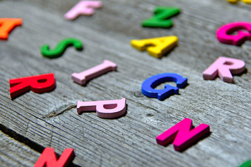 colorful wooden letters on old wooden board