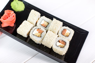 Sushi and rolls on black plate. Sea healthy japanese asian food