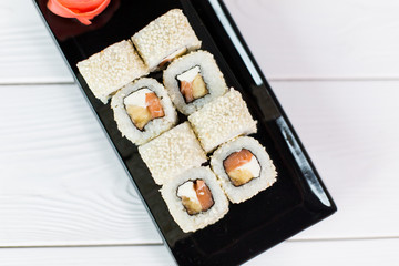 Sushi and rolls on black plate. Sea healthy japanese asian food