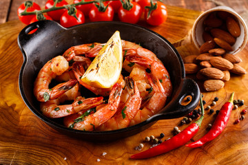 Fried large shrimp in tomato sauce with olive oil, garlic, cilantro and soy sauce, next ingredients for cooking