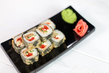 Sushi and rolls on black plate. Sea healthy japanese asian food