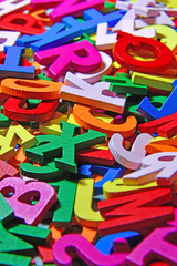 colorful wooden letters on old wooden board