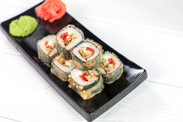 Sushi and rolls on black plate. Sea healthy japanese asian food