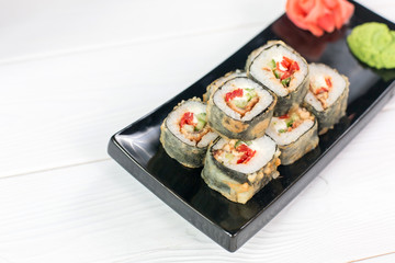 Sushi and rolls on black plate. Sea healthy japanese asian food