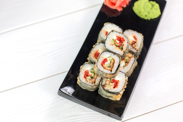 Sushi and rolls on black plate. Sea healthy japanese asian food