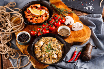 Fried large shrimp in tomato sauce with olive oil,Mushrooms in cream sauce, julienne, champignon, products for cooking