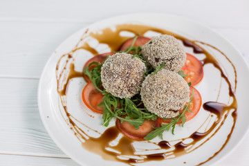 Fresh salat with tomatoes, rucola and meat rolls with sauce