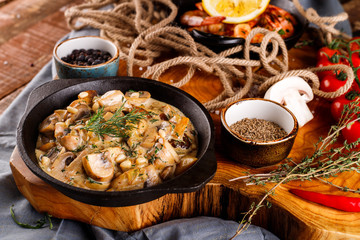 Fried large shrimp in tomato sauce with olive oil,Mushrooms in cream sauce, julienne, champignon, products for cooking