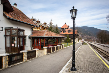 Naklejka premium Old railroad station with narrow gauge railway track, popular tourist attraction known as sarganska osmica in Mokra Gora village in Serbia.