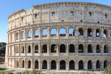 Fototapeta na wymiar The Colosseum is a symbol of the strength, power and age-old history of Rome. It is considered the most beautiful and largest stadium of the ancient world. Ancient amphitheater.