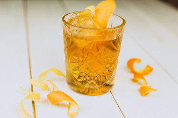 Colorful drink with fresh fruits in glass cup on white wooden background