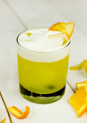 Alcoholic or non-alcoholic cocktail with fresh fruit on a white wooden background.