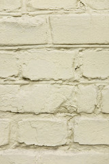 The texture of the old brick wall which is painted. Vertical photo of a brick wall. Texture for design