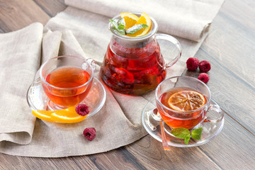 Citrus vitamin natural organic hot tea with berries and citrus fruits in glass spot with cups